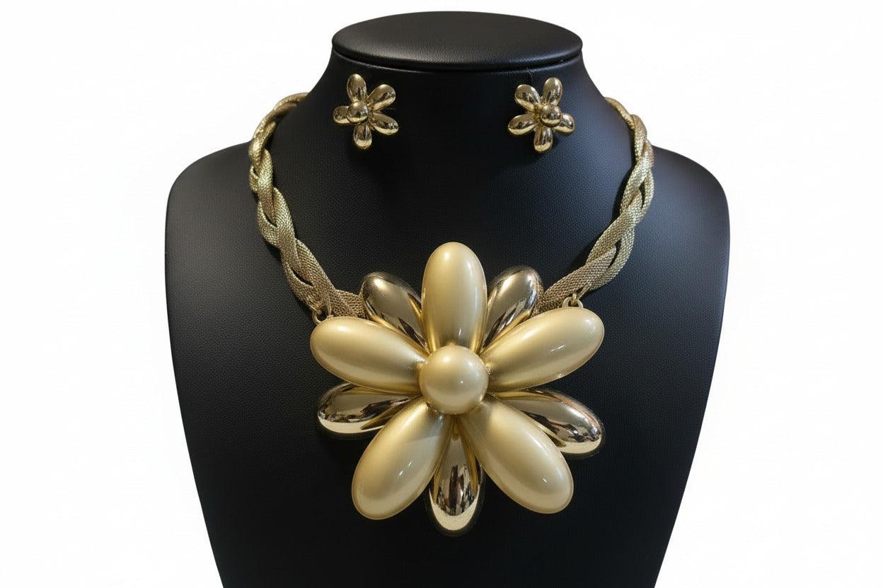 Gold flower-shape brooch on white fur background
